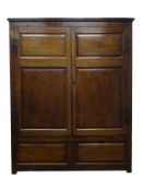 George lll oak press cupboard enclosed by a pair of twin raised and fielded panel doors,