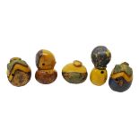 Five Japanese Meiji carved Tagua nut Netsukes each decorated with metallic pigment,