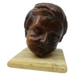 19th century French carved mahogany head of a young boy on stone plinth,