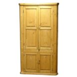 18th century country pine corner cupboard, shelved interior enclosed by four fielded panelled doors,