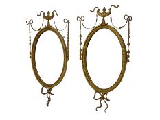 Pair of Edwardian Adam Revival carved gilt wood and gesso wall mirrors,