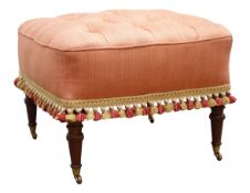 Square footstool upholstered in salmon fabric, deep buttoned top with tasselled fringe,