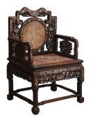 Chinese Qing period Padouk wood armchair, pierced and carved with dragons and foliage,