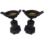 Pair bronze two handled urns with grape vine vase bowls on black marble column plinths, H23.