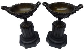 Pair bronze two handled urns with grape vine vase bowls on black marble column plinths, H23.