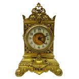 Late Victorian mantle clock with ornate cast and pierced brass case,