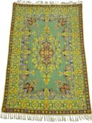 An Iranian lined silk tapestry wall hanging, the central oblong panel with floral motif in purple,