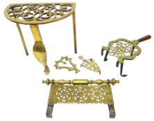 Early 19th century pierced brass trivet raised on three legs, H31cm,