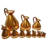 Graduated set of ten 19th century copper measuring jugs; 2, 1, 1/2 and 1/4 gallon, 1 and 1/2 pint,