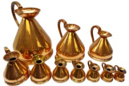 Graduated set of ten 19th century copper measuring jugs; 2, 1, 1/2 and 1/4 gallon, 1 and 1/2 pint,