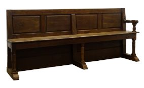 Large 19th century oak church pew, with four panel back, plank seat with end arm rest,