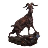 Mid-20th century bronze figure of a mountain goat standing atop a stepped rocky base,