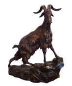 Mid-20th century bronze figure of a mountain goat standing atop a stepped rocky base,