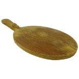 'Mouseman' oak oval cheese board by Robert Thompson of Kilburn with carved mouse signature,