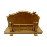 'Wrenman' oak letter rack, with five bar gate, the shaped back with carved wren signature,