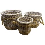 Three graduating wicker log baskets with rope work handles,