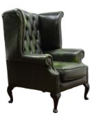 George lll style wing back armchair upholstered in deep buttoned green leather on cabriole supports,