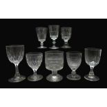 Eight 19th century glass goblets all having faceted or cut bowls, H18.