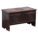 Small 17th century oak planked coffer, hinged moulded top with carved spandrels and centre motifs,