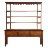 18th century and later dresser, four tier open back with projecting cornice and shaped frieze,