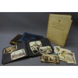 Three photograph albums containing Edwardian and later postcards and photographs including RP and
