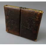 Victorian photo album, double folding embossed leather cover with brass clasps,