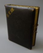 Victorian photograph album, leather bound with gilt initials and edges and brass clasp,