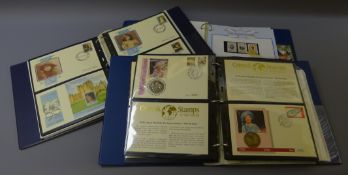 Three 'The Royal Family' ring binder folders containing Queen Elizabeth II stamps,