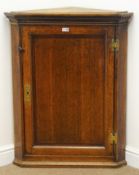 19th century oak corner cupboard, single panelled door, three shaped shelves, W78cm, H97cm,