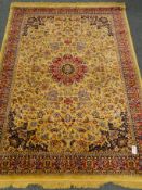 Kashmir style beige ground rug, central medallion with floral field and repeating border,