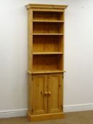 Solid pine narrow plate rack, projecting cornice, three shelves, two cupboard doors, plinth base,