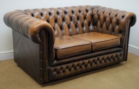 Chesterfield two seat sofa upholstered in deep buttoned brown leather,