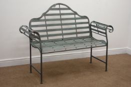 Wrought metal rustic grey garden bench with curved arms and shaped back,