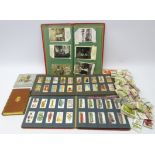 Cigarette cards in albums and loose, postcard album of mostly Edwardian postcards,
