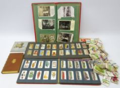 Cigarette cards in albums and loose, postcard album of mostly Edwardian postcards,