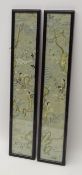 Pair Chinese silk embroidered sleeve panels depicting figures in a landscape in ebonised frames,