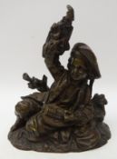 19th century bronze model of a young street performer, the boy laid with a musical instrument,