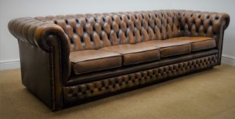 Chesterfield four seat sofa upholstered in deep buttoned brown leather,
