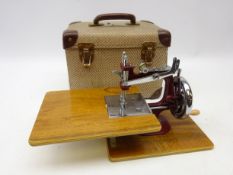 Vintage children's sewing machine in original case
