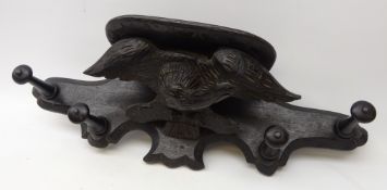 Black Forest carved ebonised oak coat rack, eagle surmount with wings outstretched,
