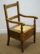 19th century country commode armchair, ladder back, daisy chain cane seat, on turned supports,