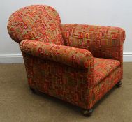 Early 20th century armchair, upholstered in a red and green geometric patterned fabric,