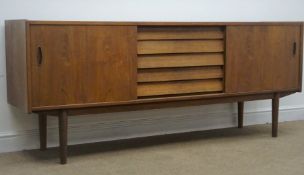 Retro teak sideboard, five drawers flanked by two sliding cupboards, turned tapering supports,