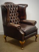 Queen Anne style wingback armchair, upholstered in deep buttoned brown leather, cabriole feet,