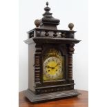 Large Edwardian stained and walnut architectural cased mantel clock with arched brass Roman dial,