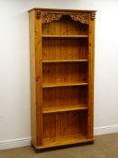 Solid pine 6' open bookcase, moulded top, foliage and grape carved and pierced frieze, reeded sides,
