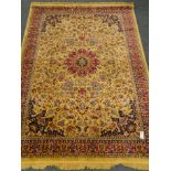 Kashmir style beige ground rug, central medallion with floral field and repeating border,