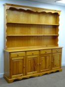 Pine farmhouse dresser, two tier plate rack above four drawers and cupboards, shaped plinth base,