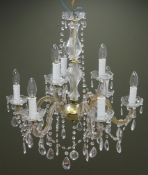 Clear glass nine branch chandelier with cut glass drops, gilt frame and scrolled arms,