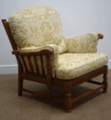 Ercol medium elm framed armchair, carved cresting rail, turned splat and legs joined by stretchers,